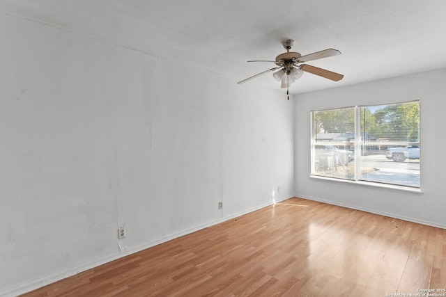 spare room with light hardwood / wood-style flooring and ceiling fan