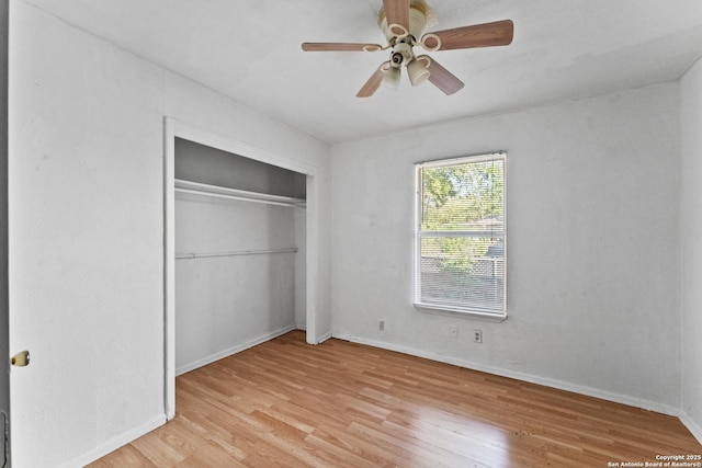 unfurnished bedroom featuring light hardwood / wood-style flooring, a closet, and ceiling fan