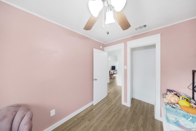 hall with crown molding and hardwood / wood-style floors