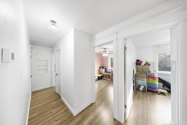 corridor with light hardwood / wood-style flooring