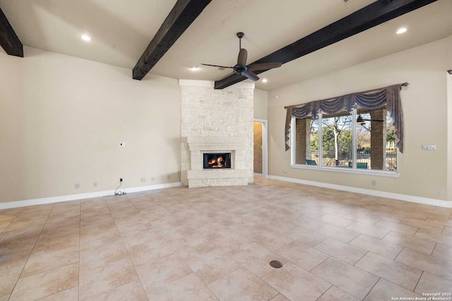 unfurnished living room featuring beamed ceiling, a fireplace, and ceiling fan