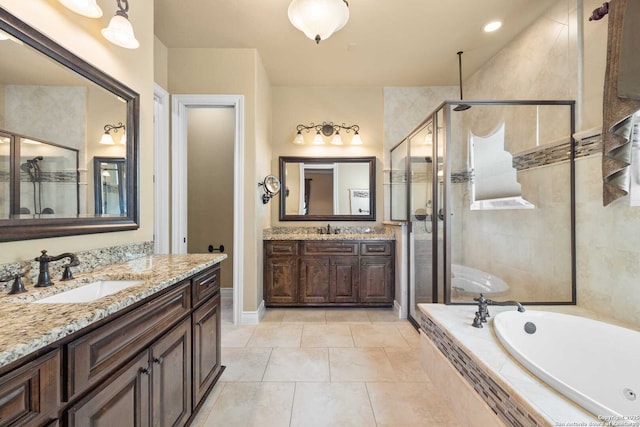 bathroom with vanity, tile patterned flooring, and plus walk in shower