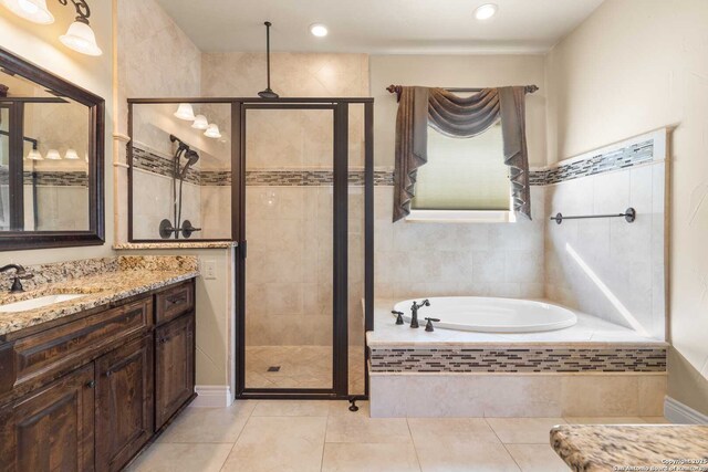 bathroom with vanity, independent shower and bath, and tile patterned flooring