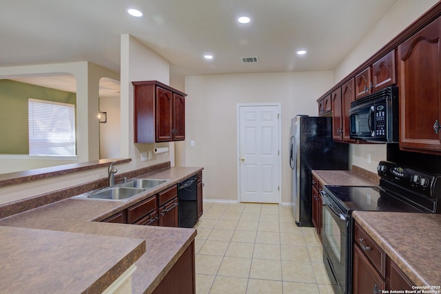 kitchen with sink, light tile patterned floors, and black appliances