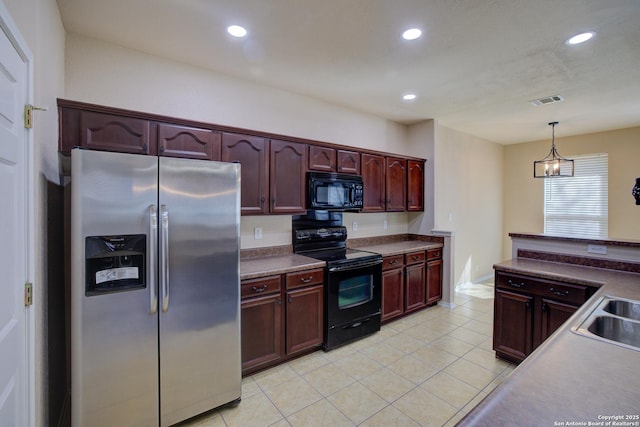 kitchen with sink, light tile patterned floors, hanging light fixtures, and black appliances