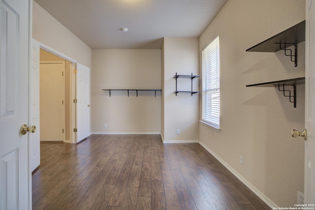 empty room with dark wood-type flooring