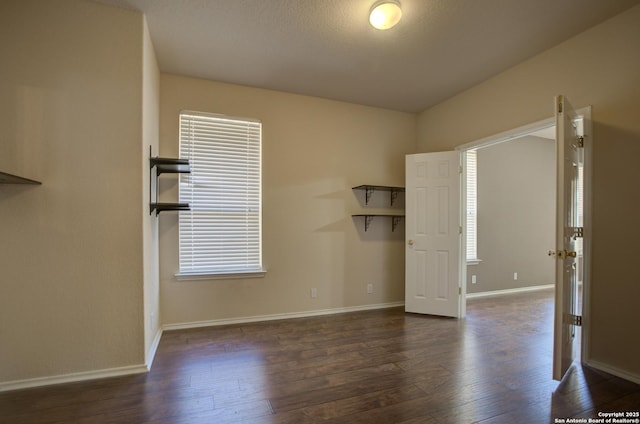 empty room featuring dark wood-type flooring