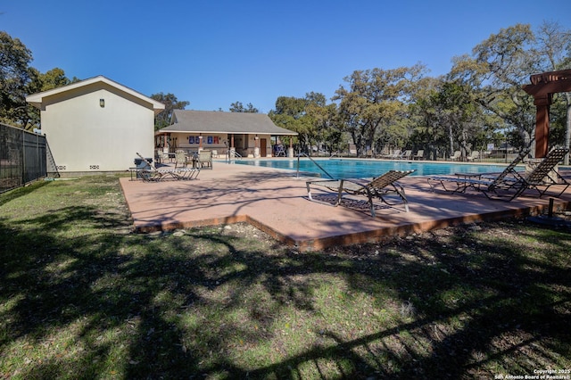 view of pool with a yard and a patio area