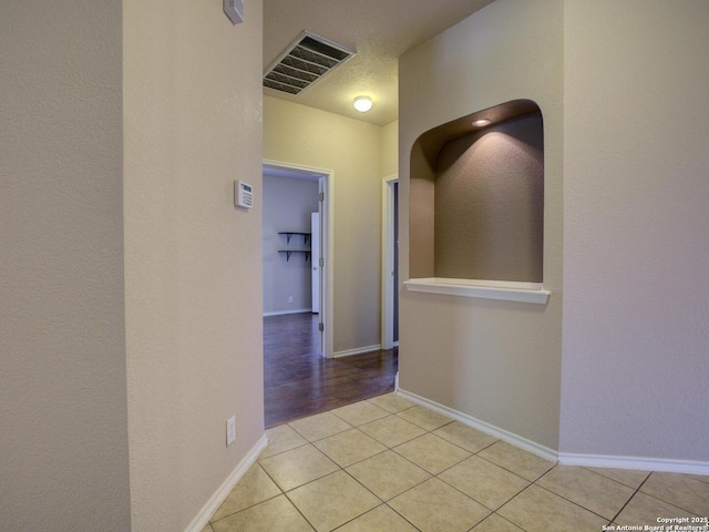 hallway featuring light tile patterned floors