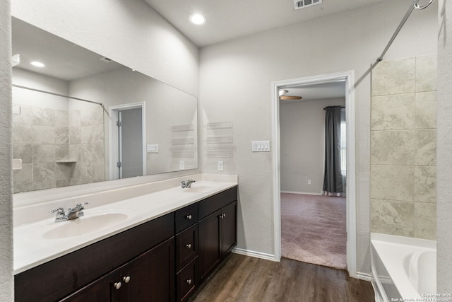 bathroom with vanity, hardwood / wood-style flooring, and bathtub / shower combination