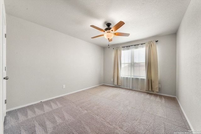 carpeted empty room featuring ceiling fan and a textured ceiling