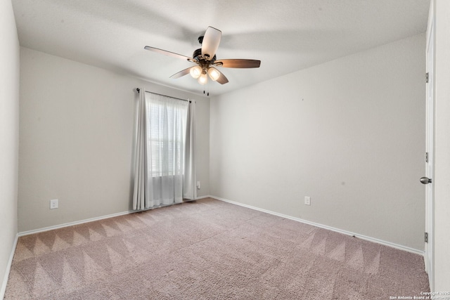 empty room with ceiling fan and light carpet