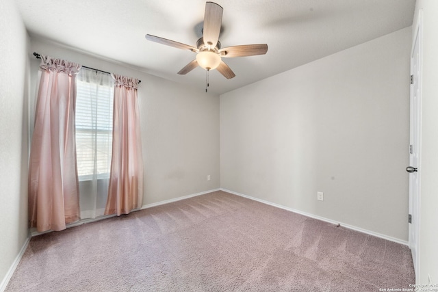 unfurnished room with light colored carpet and ceiling fan