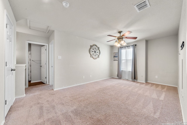 spare room featuring light carpet and ceiling fan