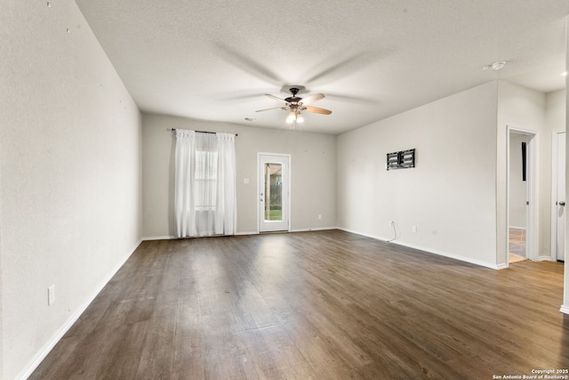 unfurnished room featuring ceiling fan, dark hardwood / wood-style floors, and a textured ceiling