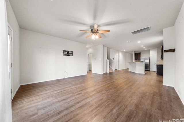 unfurnished living room with hardwood / wood-style flooring and ceiling fan