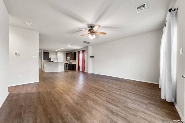 unfurnished living room featuring ceiling fan and dark hardwood / wood-style floors