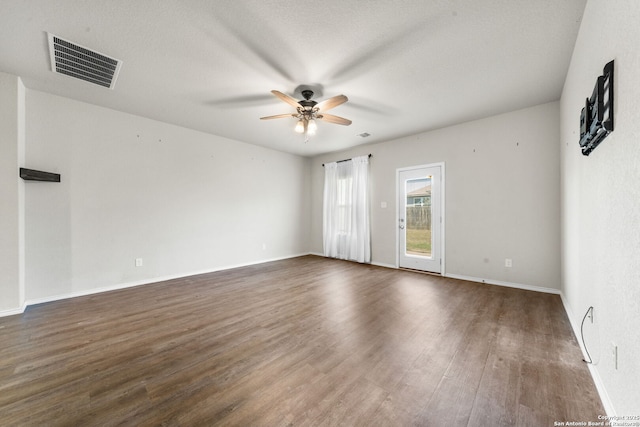 spare room featuring a textured ceiling, dark hardwood / wood-style floors, and ceiling fan