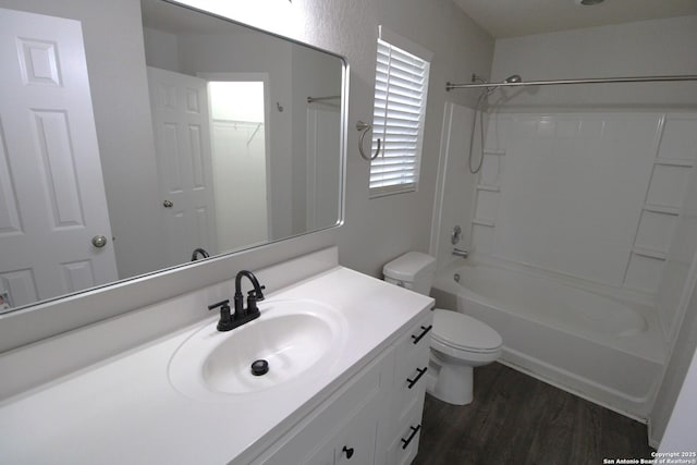 full bathroom featuring hardwood / wood-style flooring, vanity, shower / bathtub combination, and toilet