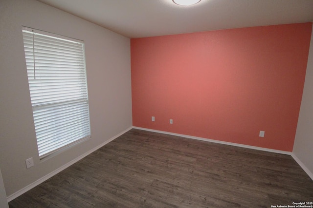 unfurnished room with dark hardwood / wood-style floors