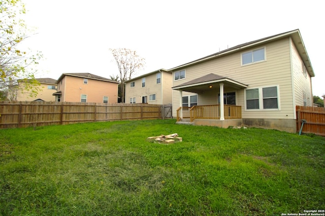 back of house featuring a yard