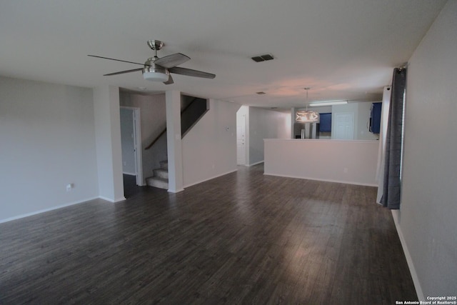 unfurnished living room with dark hardwood / wood-style flooring and ceiling fan