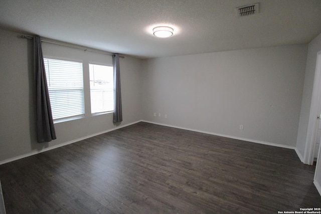 empty room with dark hardwood / wood-style floors