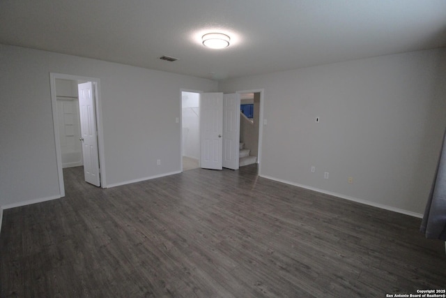 empty room with dark hardwood / wood-style flooring