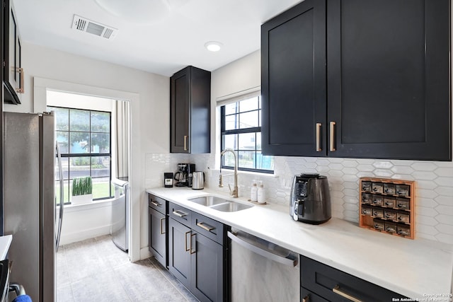 kitchen with stainless steel appliances, tasteful backsplash, plenty of natural light, and sink