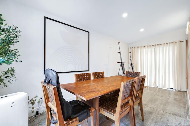 dining space featuring vaulted ceiling