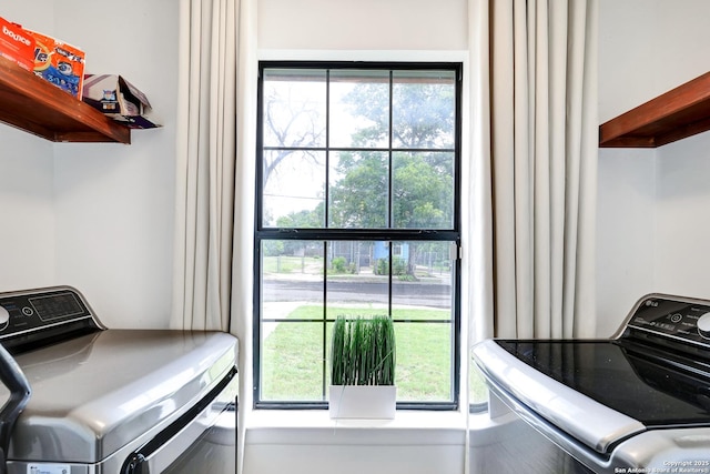 washroom with a healthy amount of sunlight and washer and clothes dryer