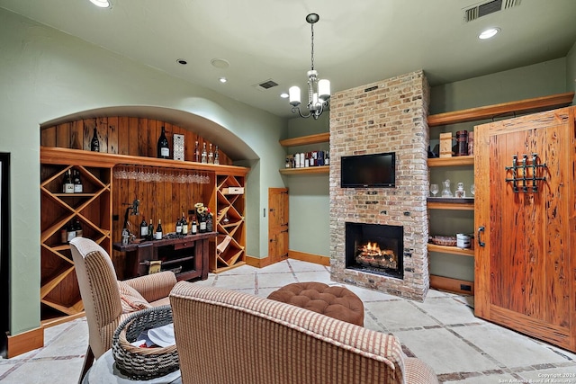 interior space with a fireplace and a notable chandelier