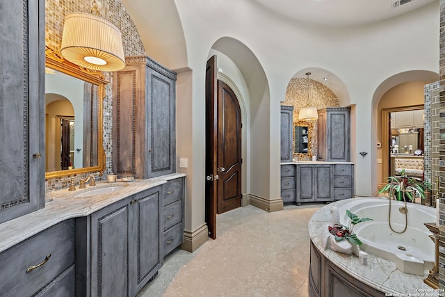 bathroom featuring a tub to relax in and vanity