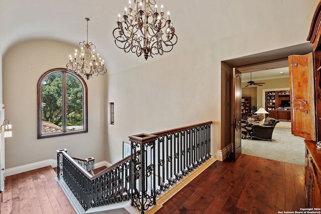 hall featuring hardwood / wood-style flooring and a chandelier