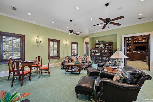 carpeted living room featuring ornamental molding and ceiling fan