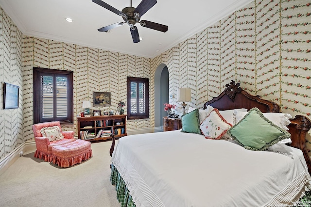 carpeted bedroom featuring crown molding and ceiling fan