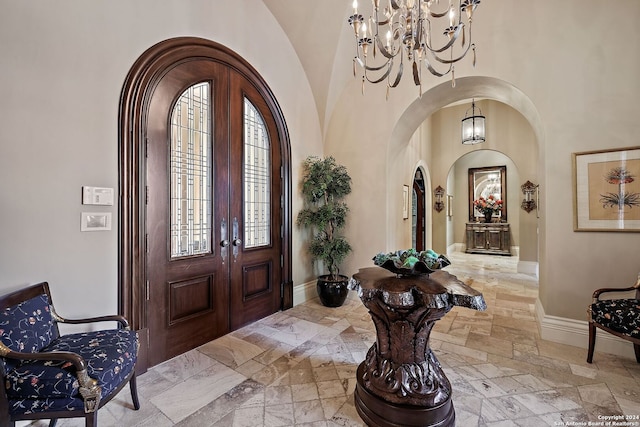 foyer entrance with french doors and a chandelier