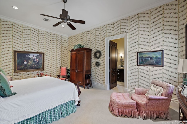 carpeted bedroom with ceiling fan, ornamental molding, and ensuite bath