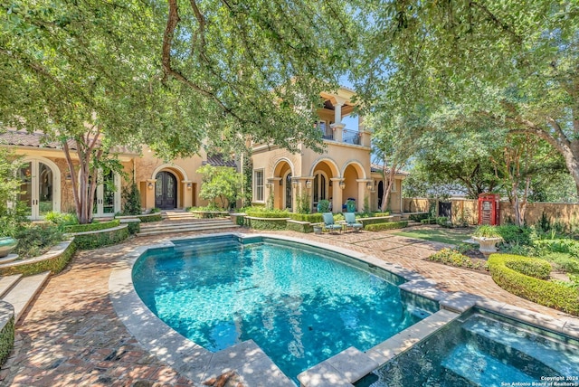 view of swimming pool with a patio and an in ground hot tub