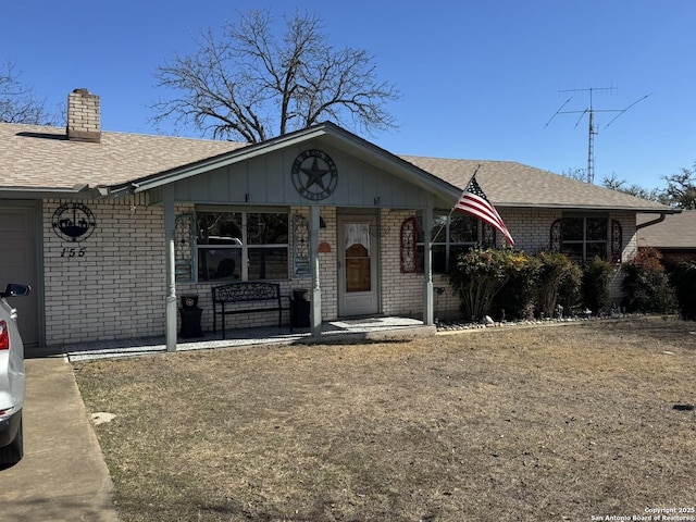 single story home with a garage and a front lawn