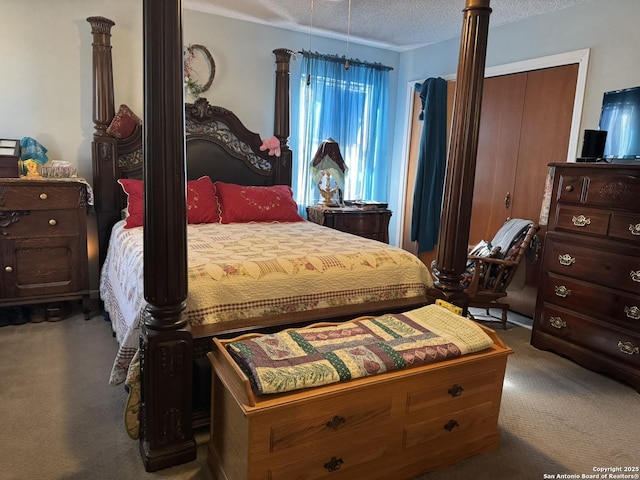 bedroom featuring a closet, carpet floors, and a textured ceiling