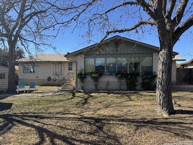 back of property featuring a yard