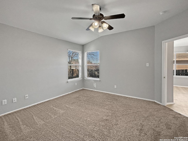 unfurnished room featuring ceiling fan, vaulted ceiling, and light carpet