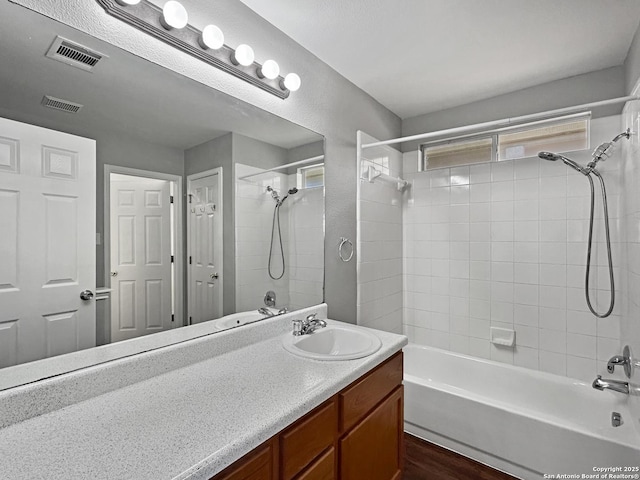 bathroom featuring vanity and tiled shower / bath combo