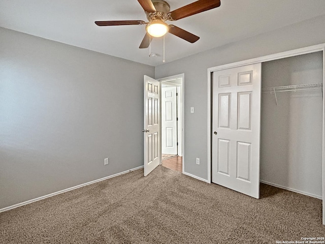 unfurnished bedroom featuring carpet, ceiling fan, and a closet