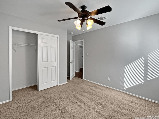 unfurnished bedroom with a closet, ceiling fan, and carpet