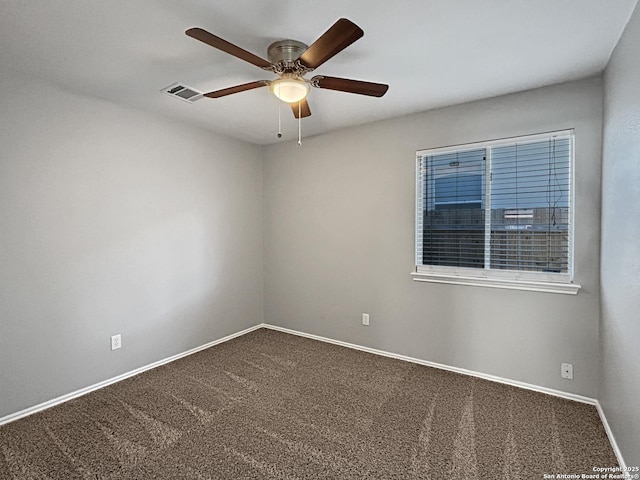 spare room featuring ceiling fan and carpet