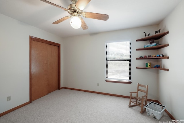 unfurnished bedroom featuring light colored carpet, ceiling fan, and a closet