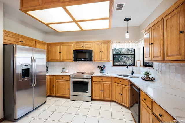 kitchen featuring tasteful backsplash, sink, hanging light fixtures, light tile patterned floors, and black appliances