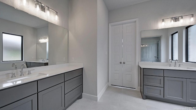 1716 Madden Hvn, San Antonio, TX 78245 - full bathroom featuring two vanities, tile patterned floors, and baseboards